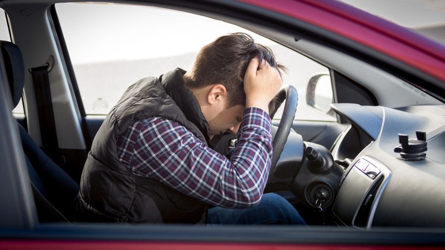 Man Feeling Stressed While Sitting In A Car