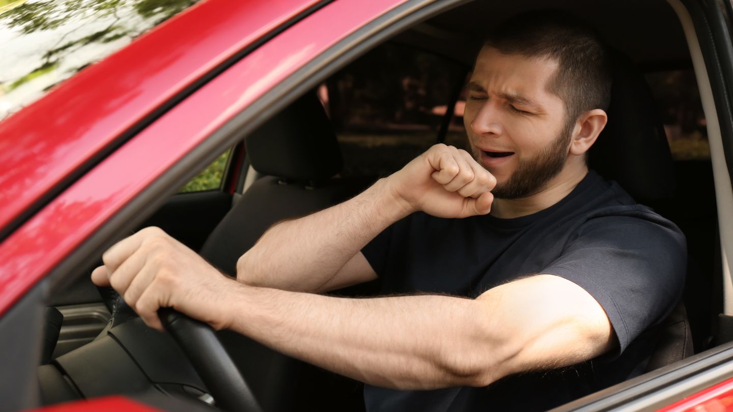 Man Yawning While Driving A Car