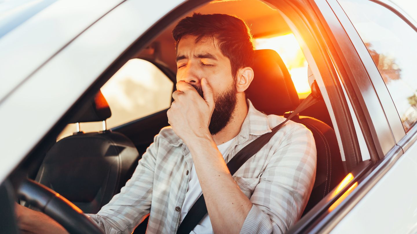  Tired Man Yawning While Driving at Sunset 