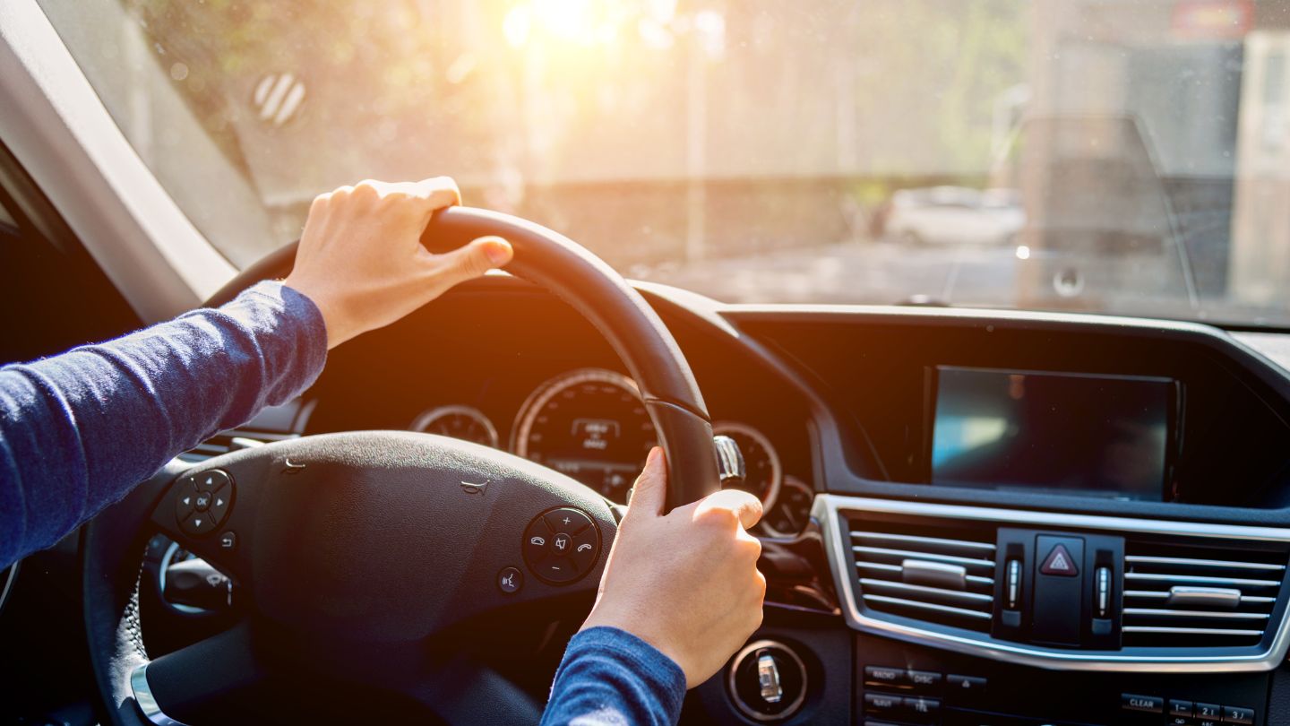 Person Holding Steering Wheel While Driving A Car
